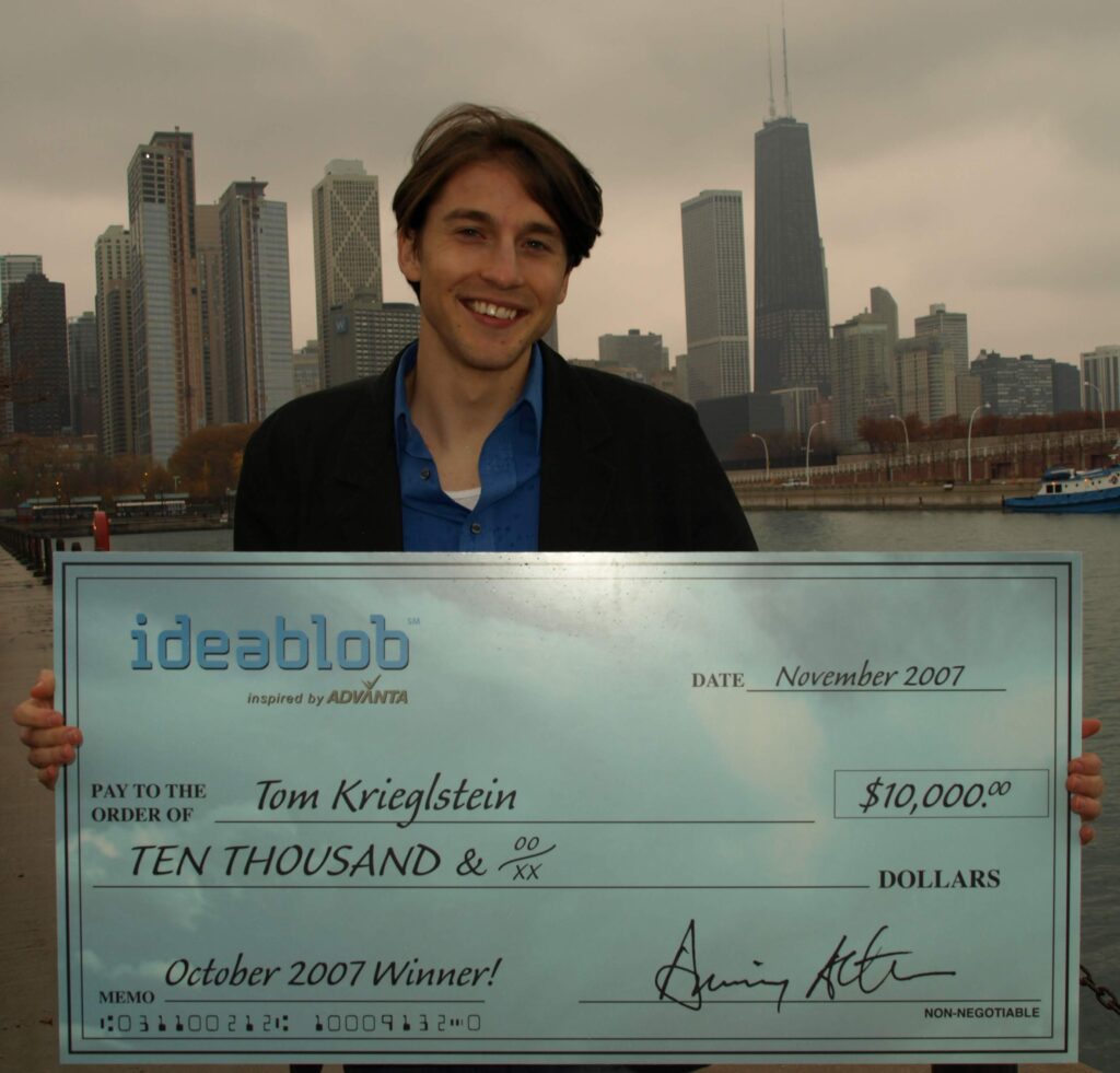 Tom holding check after winning Ideablob